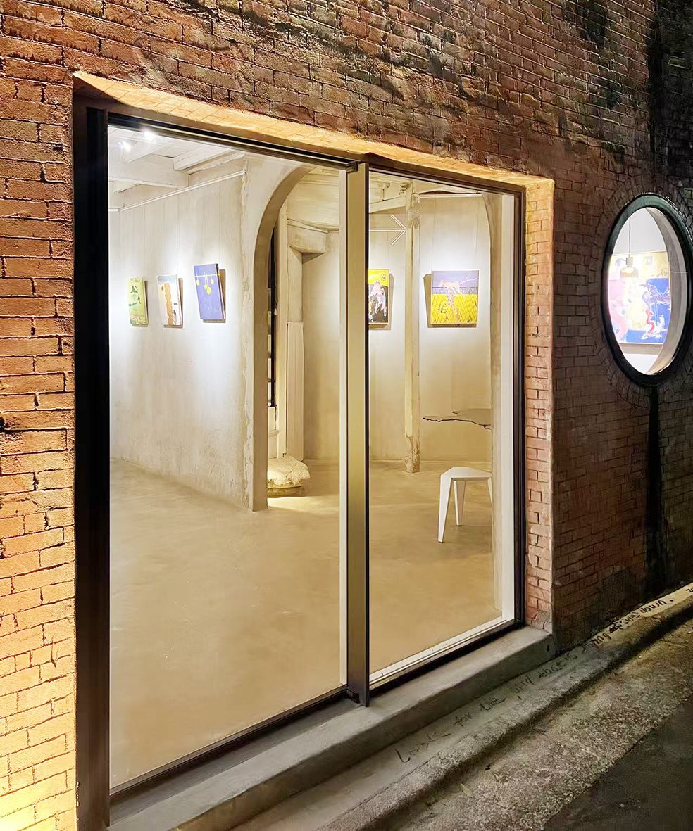 Gallery window at night, works on view